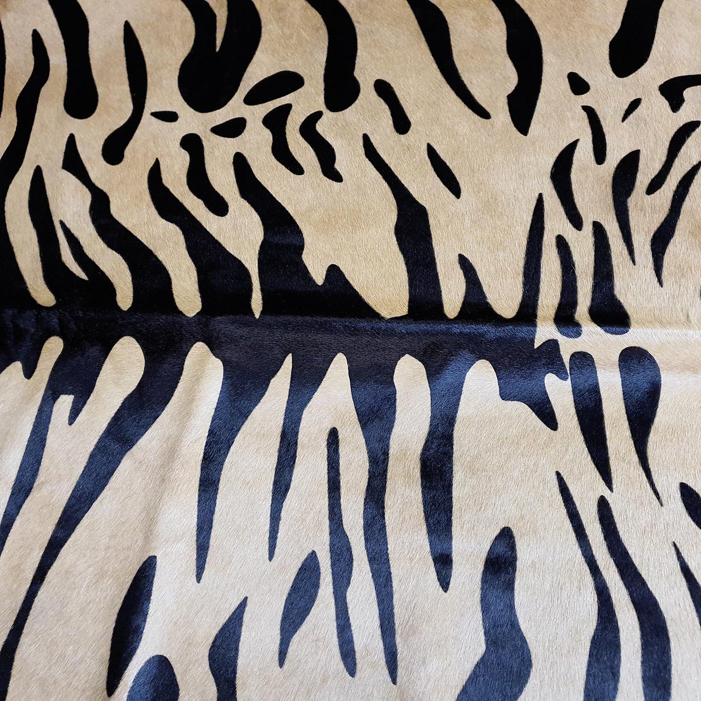Tiger Javali on Caramel Cowhide Rug